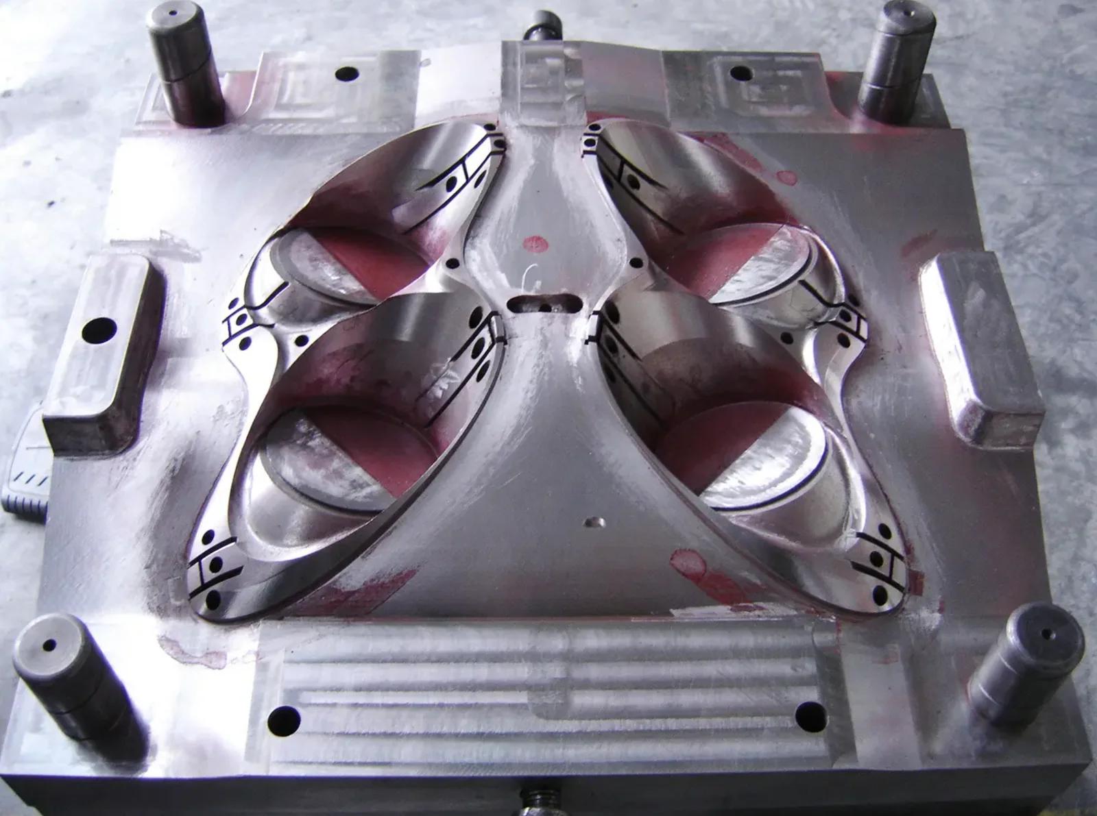 Headlamp mold cavity being machined on a cradle-type five-axis centre